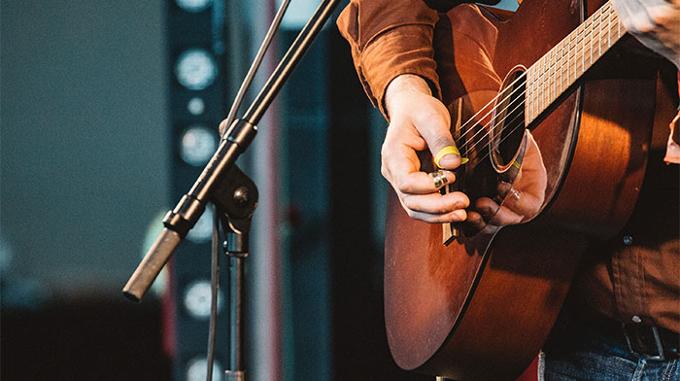 Man with Acoustic guitar on stage